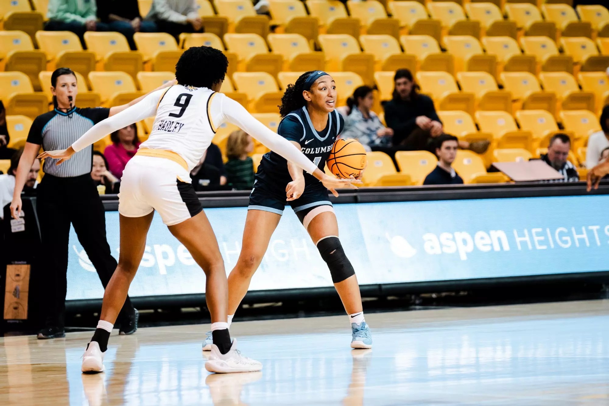 Columbia guard/forward Perri Page holds the ball in her left hand on the perimeter and points to a spot in front of her with her right hand.