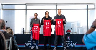 Shatori Walker-Kimbrough, Brionna Jones and Brittney Griner hold up the back of their new Atlanta Dream jerseys during their introductory press conference.