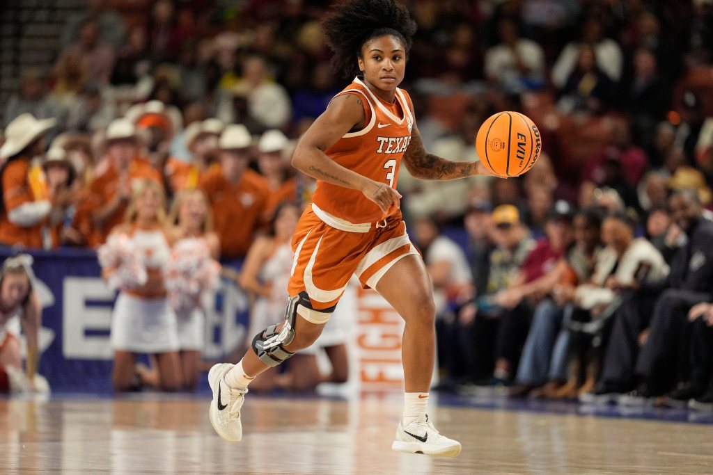 Rori Harmon dribbles the ball up the court for Texas with her left hand.