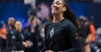 Before their matchup between the Connecticut Sun, Las Vegas Aces center A’ja Wilson smiles during her warmup routine.