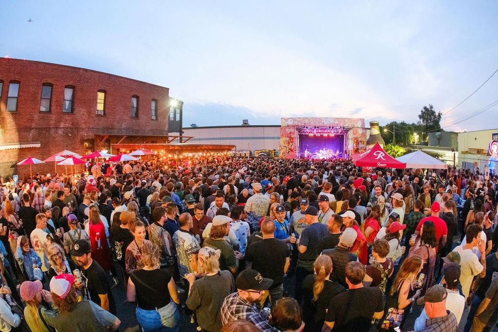 A crowd of people standing in front of a stage
