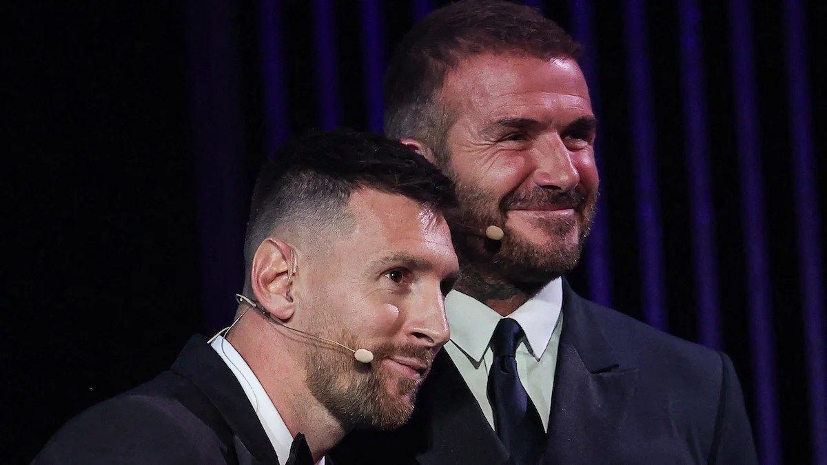 Lionel Messi reacts on stage as he receives his 8th Ballon d'Or award next to former English football player and Inter Miami's co-owner David Beckham