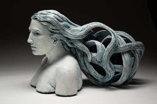 A bust of a woman with long, flowing hair.