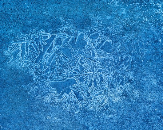 bright blue ice crawls across the water