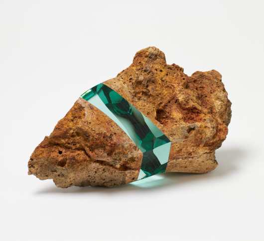 a rock including an embedded section of layered of aquamarine glass