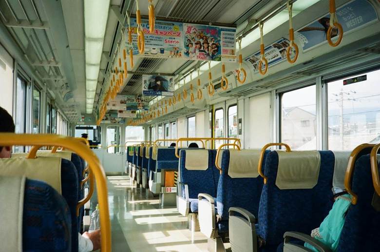 empty japanese train interior with handrails