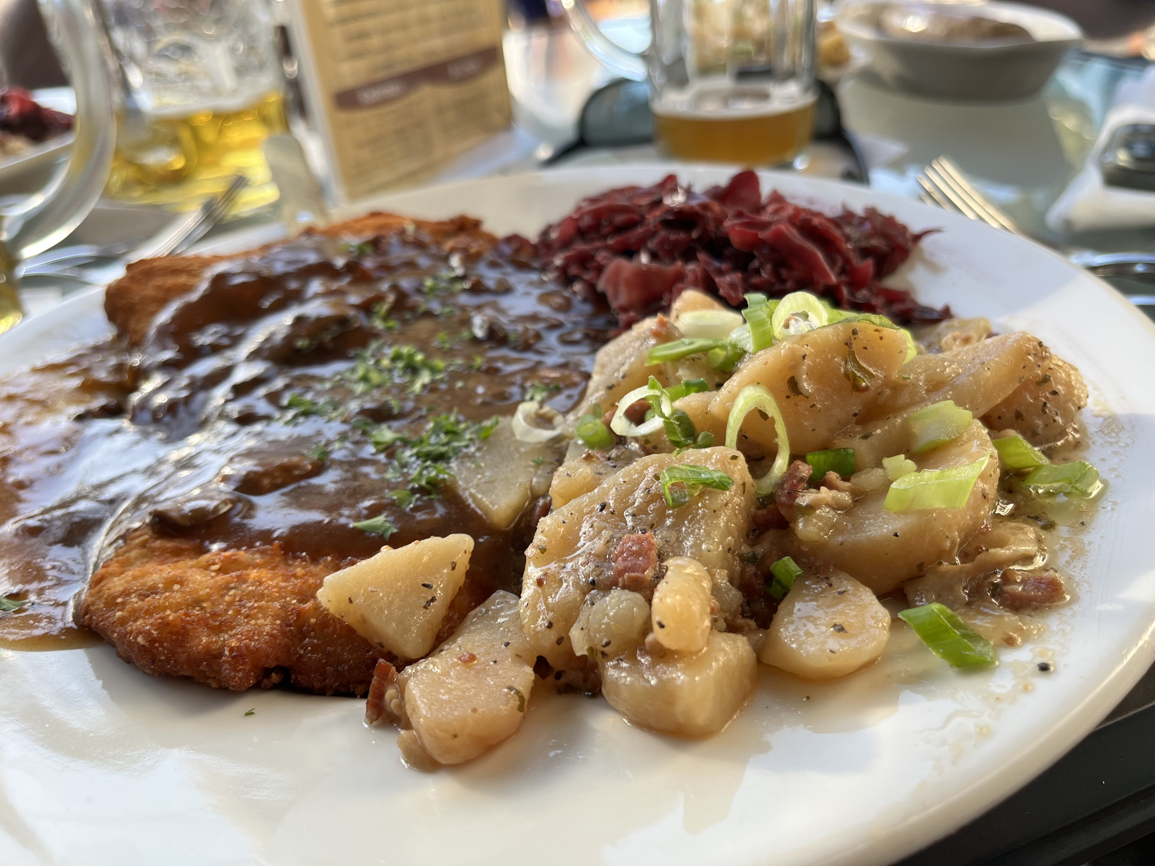 Schnitzel, potato salad and red cabbage on a plate