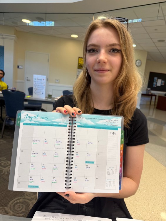 First-year student Crow Sindelar shows off their new day planner provided by the LaunchPad program. Supported by a Fund for Mary Washington Impact Grant, the four-week program gives incoming students a crash course in syllabus organization, time management, campus involvement and how to utilize computer tools like Canvas and Microsoft Office.