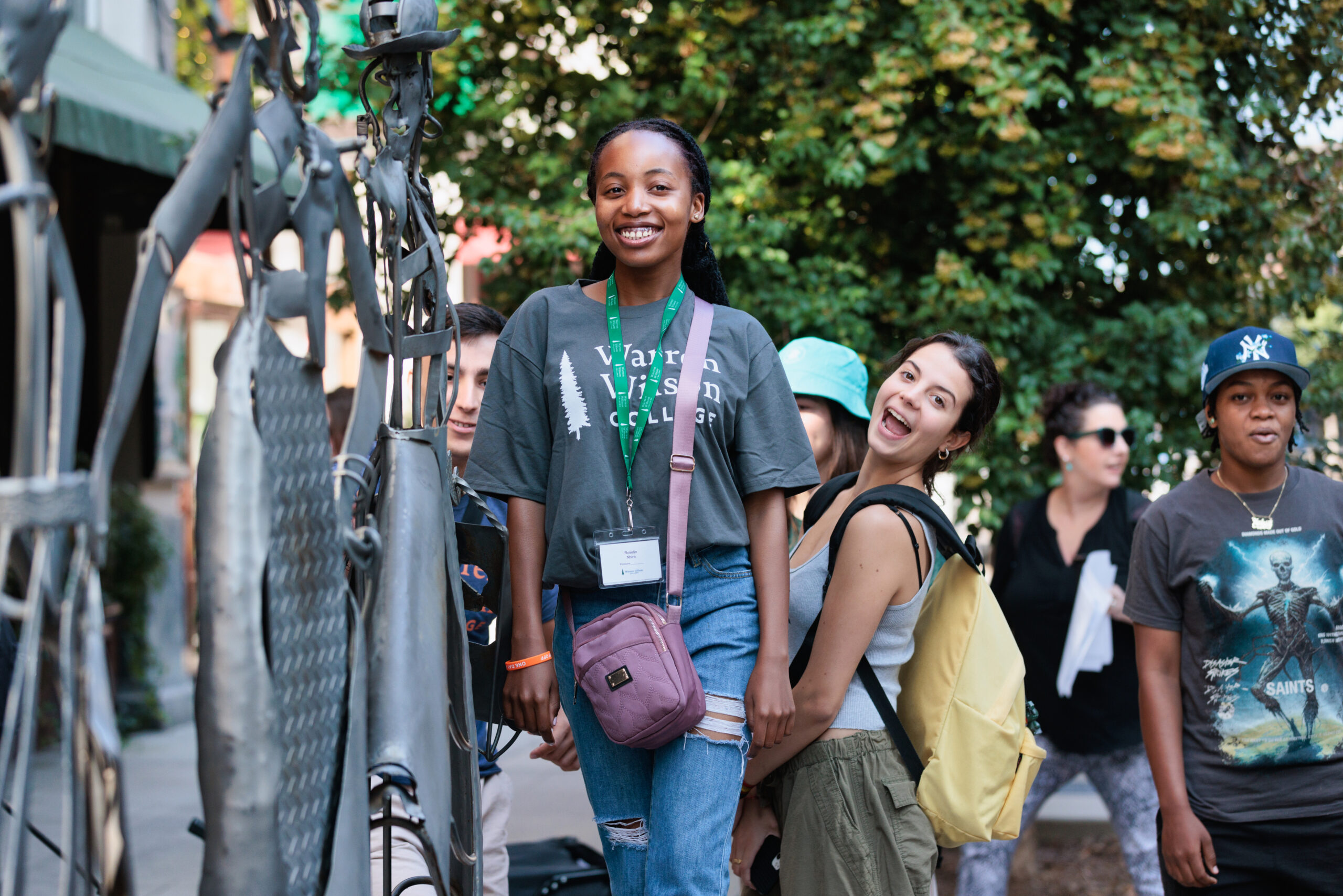 A group of students smile for a picture in downtown asheville.