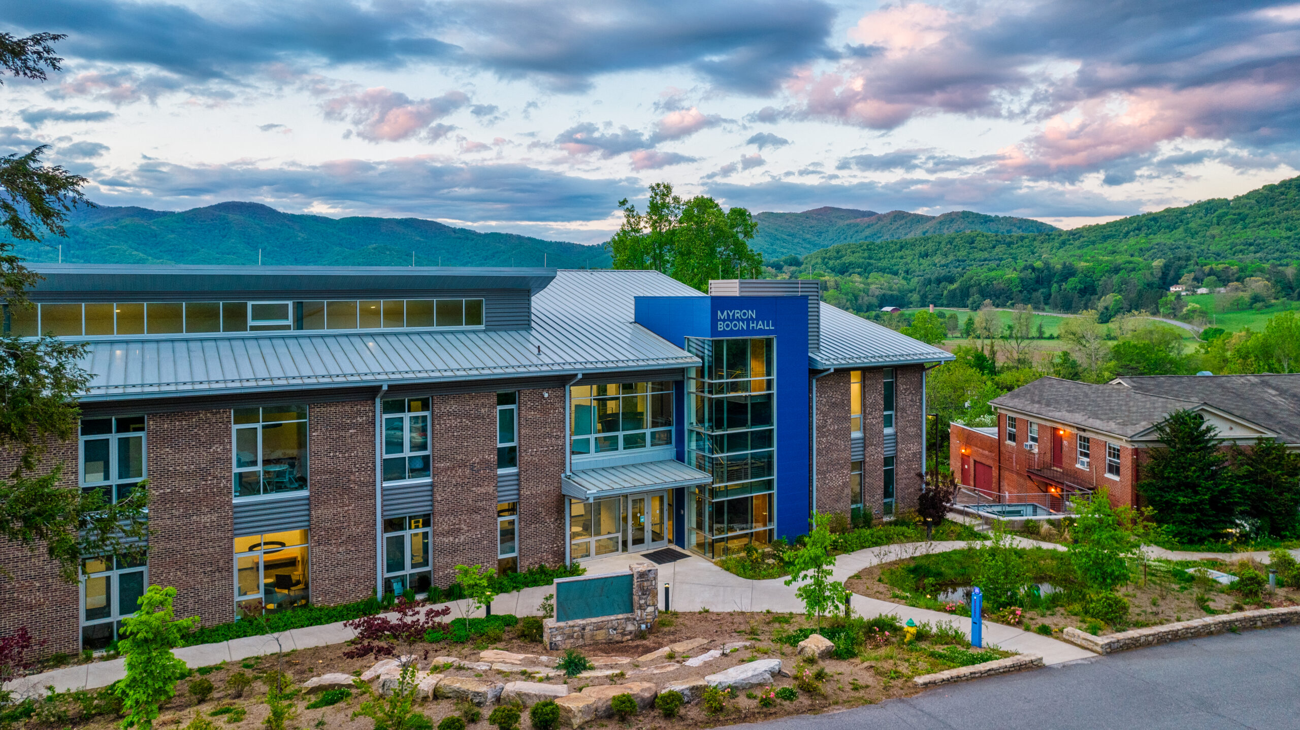An aerial photo of Myron Boon Hall. A beautiful mountain vista can be seen in the background