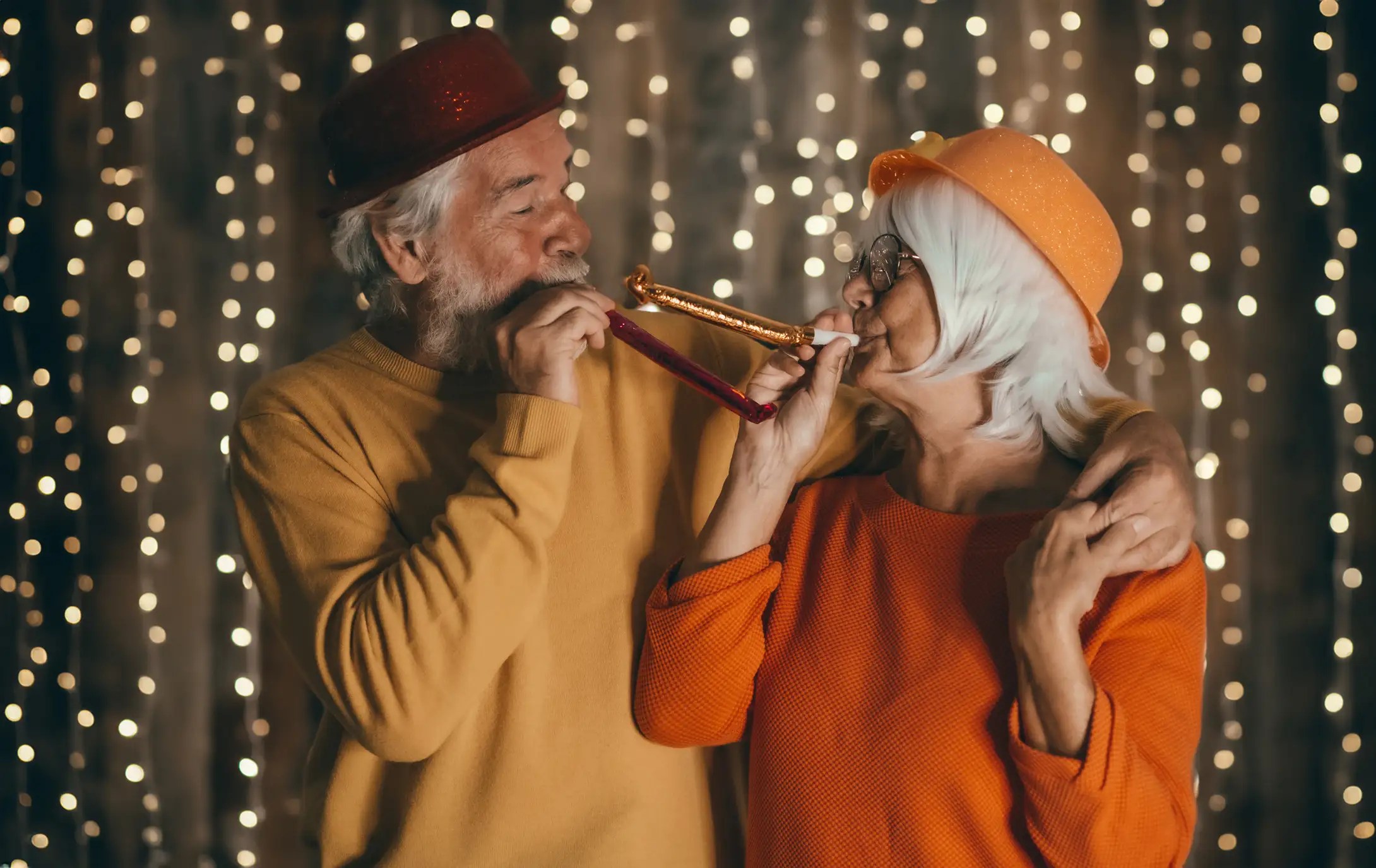 Senior couple celebrating the new year with party favors