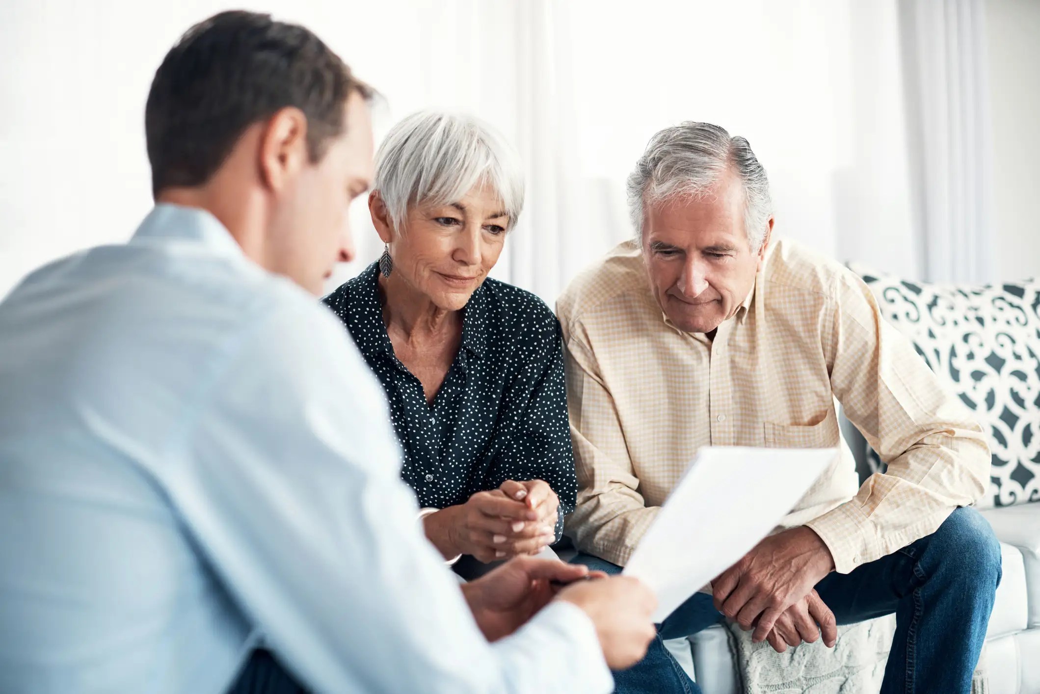 Senior couple speaking with a consultant about senior living options