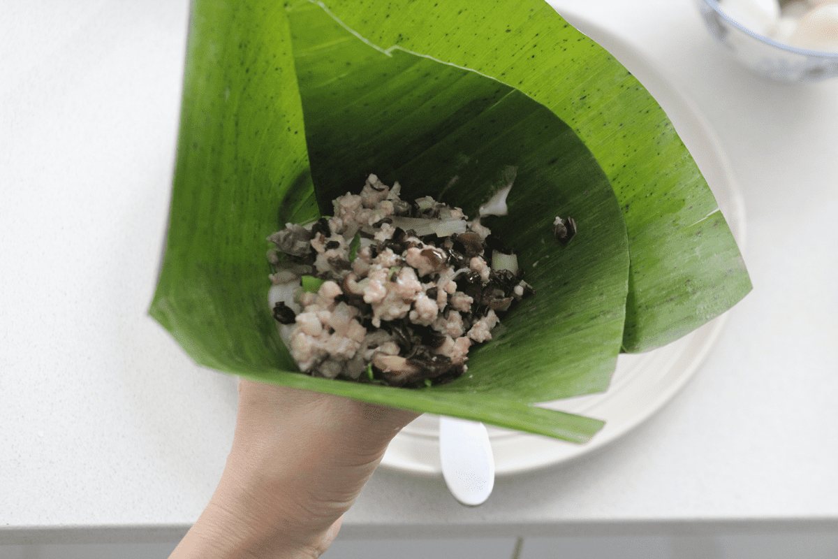Ground pork in a banana leaf.