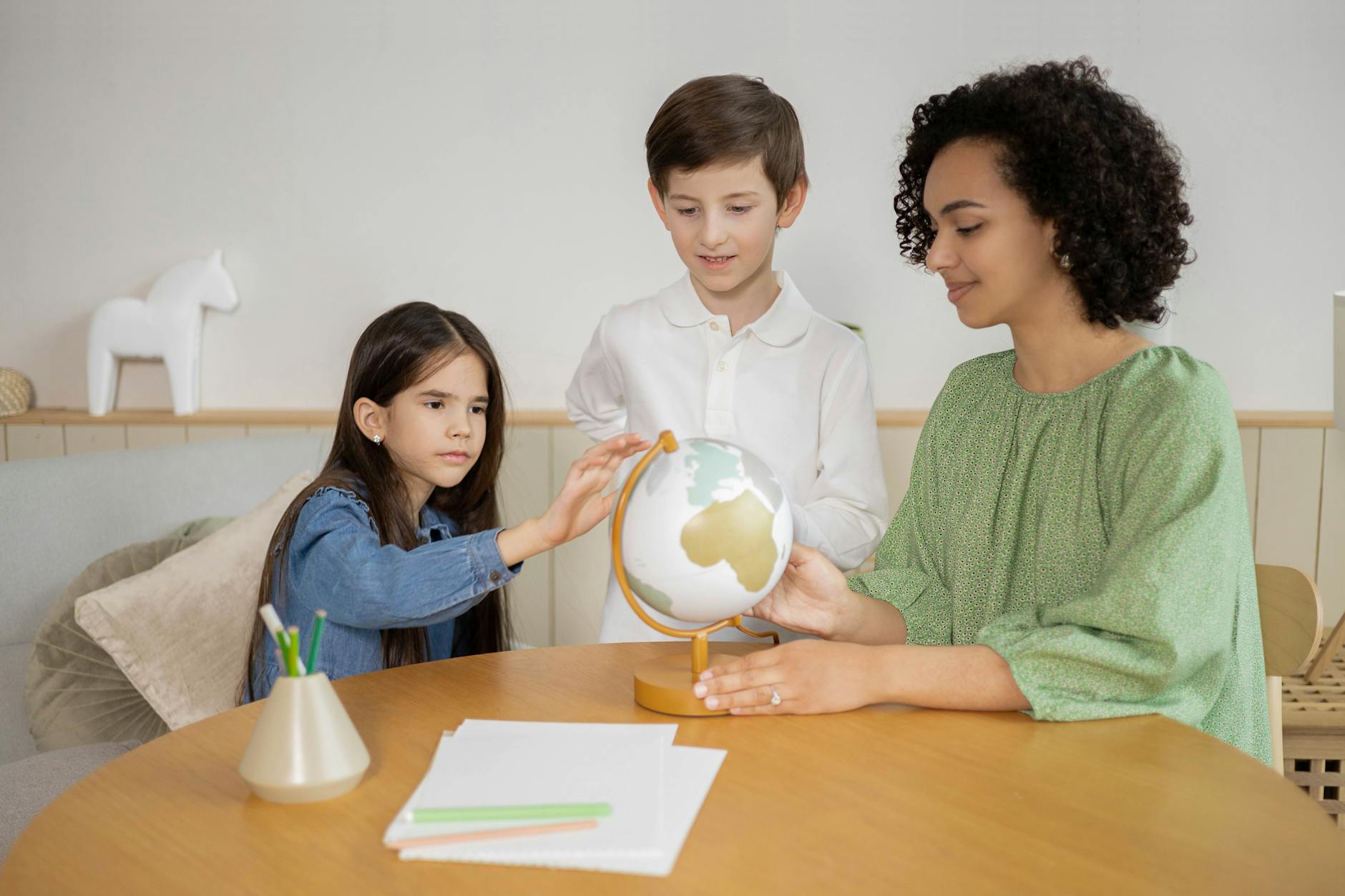 students looking at a globe