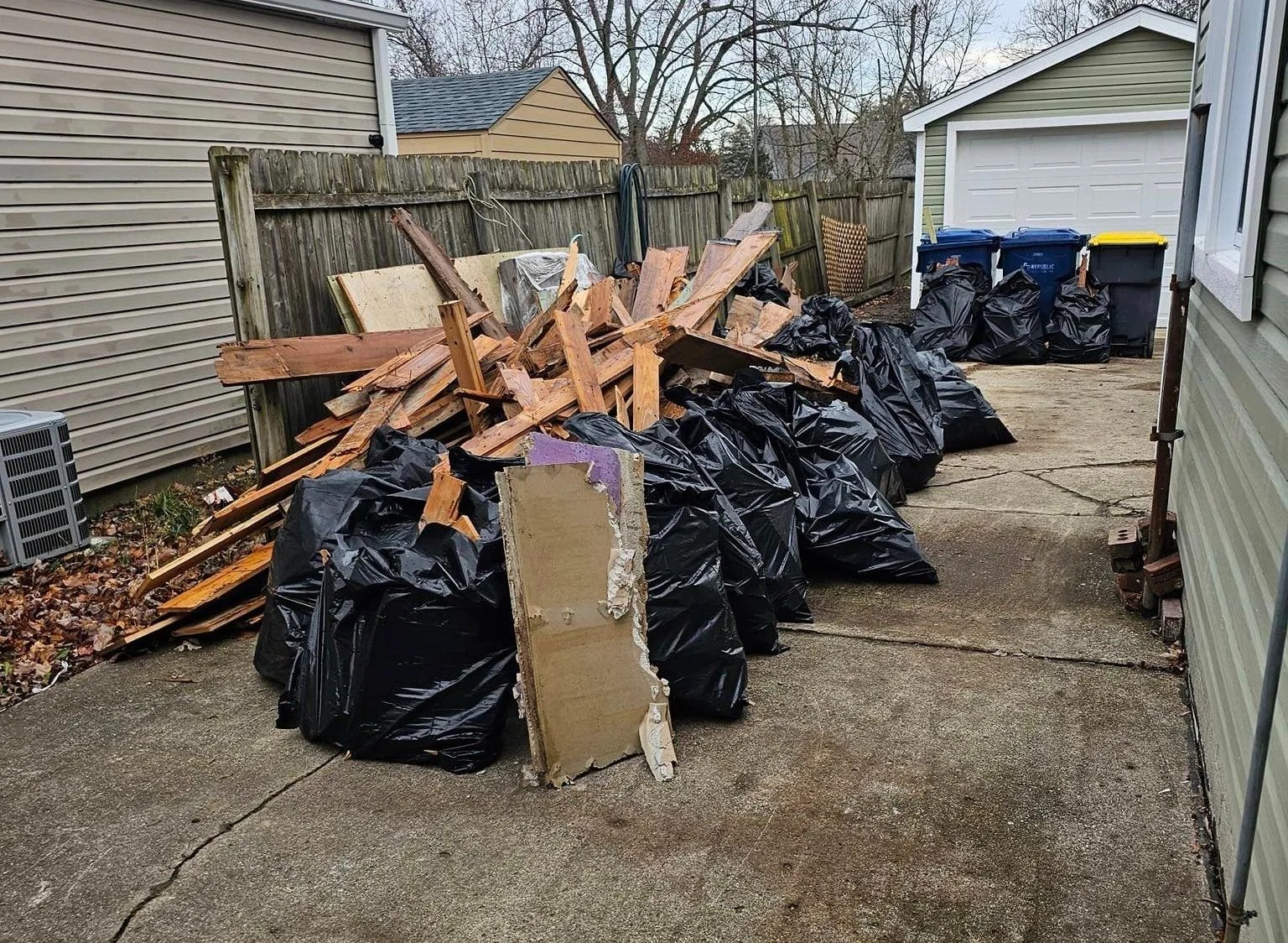 A collection of discarded materials, likely construction debris gathered in a residential or commercial space