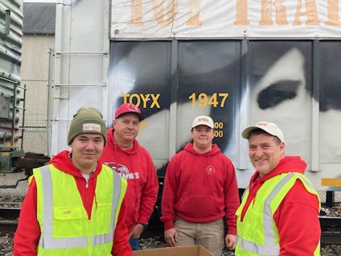 OTT volunteers Nathan Durgin, Matt Svoboda, Daniel Svoboda and Joe Mele ready to collect toys at the Warwick stop