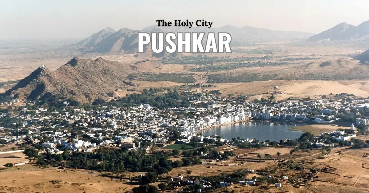 Aerial view of the holy Pushkar Lake and ghats surrounded by the Thar Desert mountains in Rajasthan India.