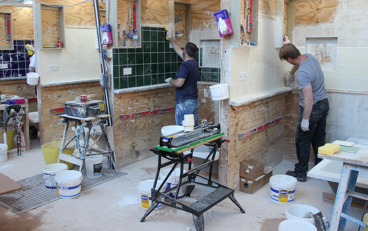 Tiling a kitchen and cutting around plugs and cupboards