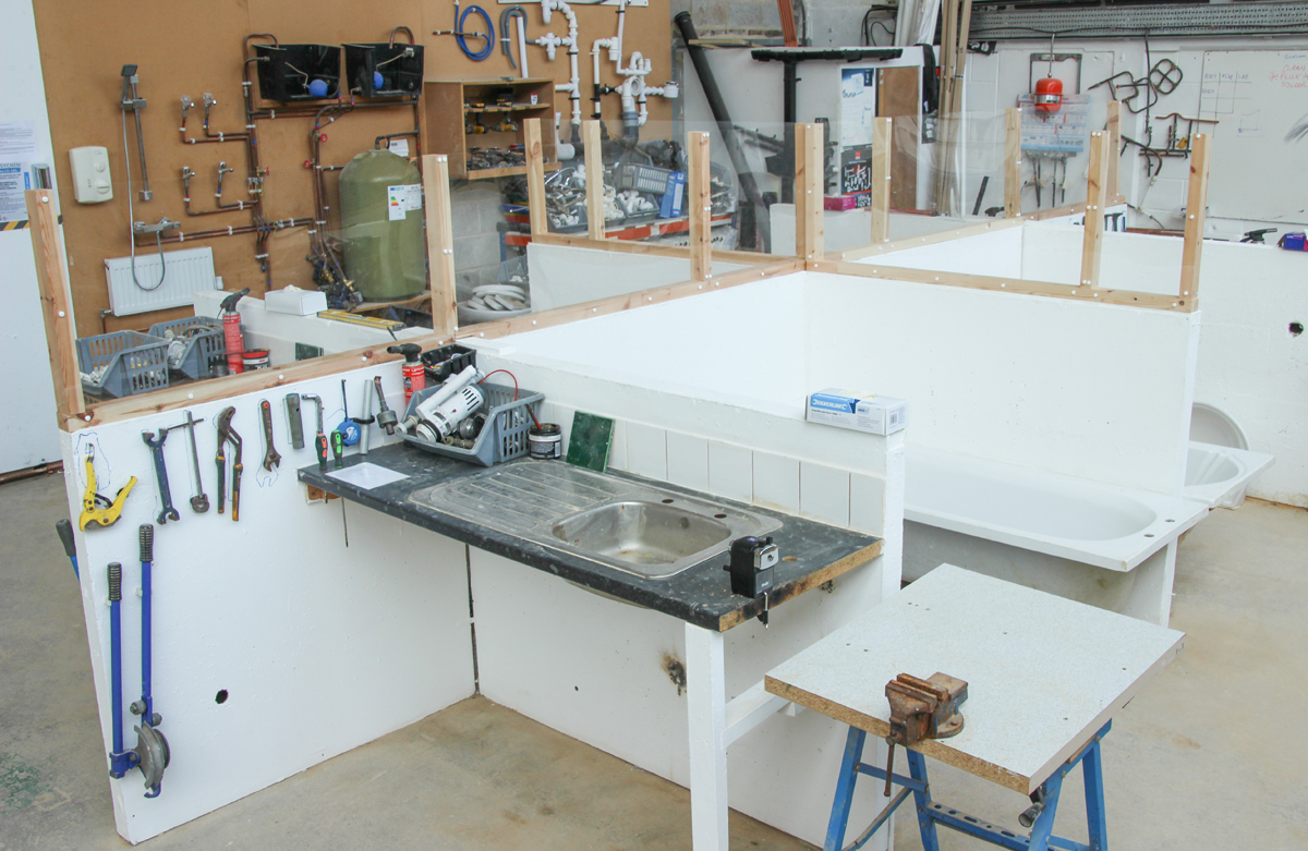 Perspex between plumbing training bays