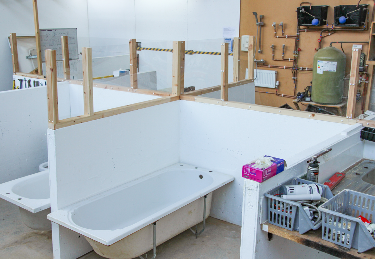 Perspex between plumbing training bays