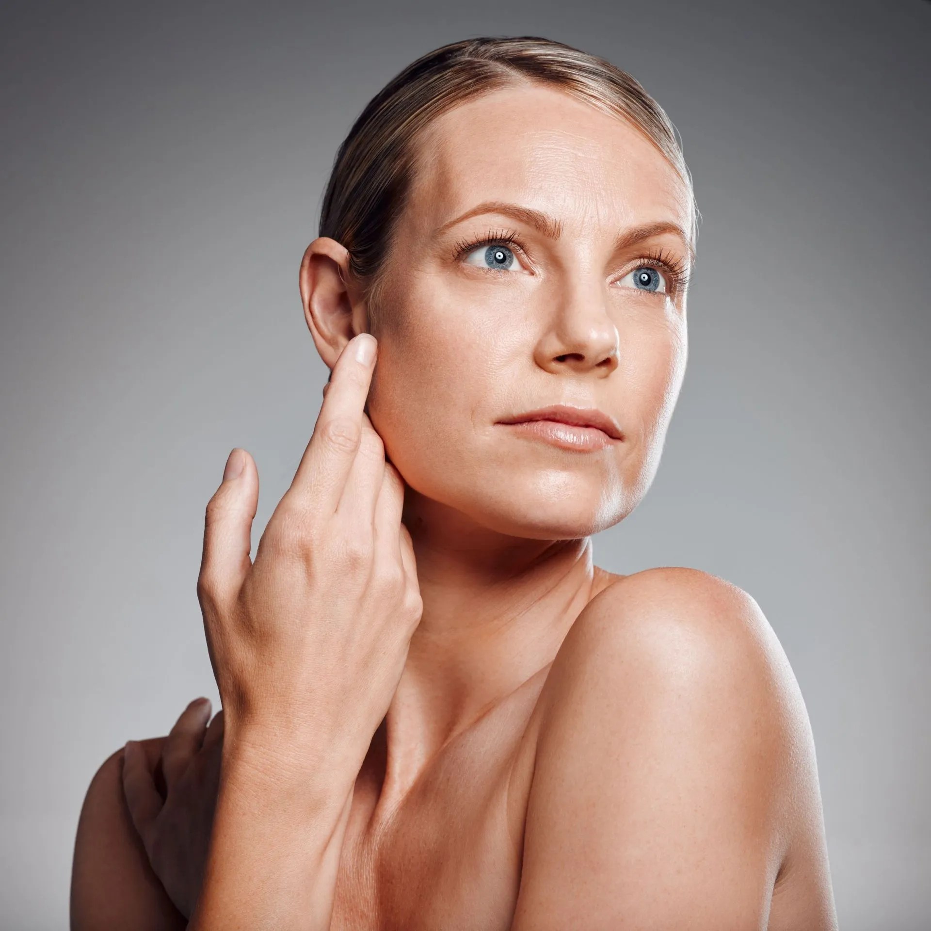 Woman-touching-face-looking-upward