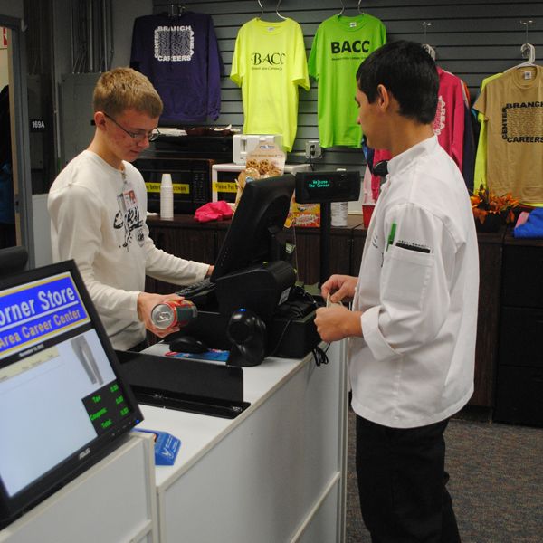 2 students working at cash register