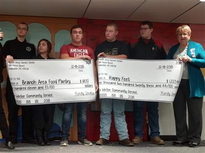 Students on the Winter Community Service committee at the Branch Area Careers Center present checks to Renate Brenneke, Branch Area Food Pantry representative, and Connie Winbigler, Altrusa International member, Wednesday, December 19, 2018 at their winter assembly.