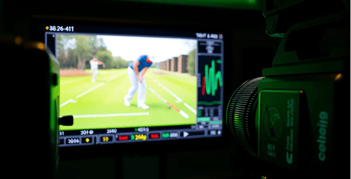 Man swinging a golf club on a digital screen.