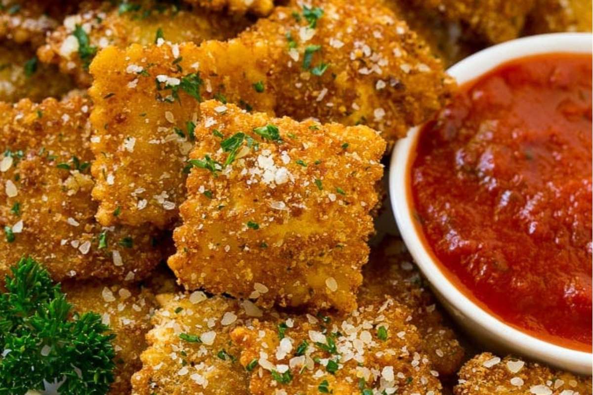 An appetizing plate of cheesy Italian crackers with a delectable dipping sauce.