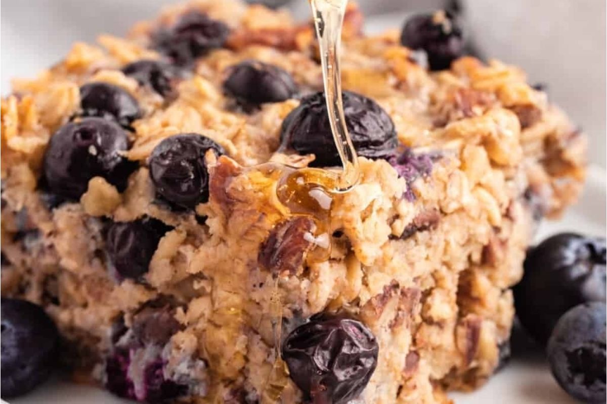 Indulge in a delicious bowl of blueberry oatmeal drizzled with honey - a perfect combination for breakfast.