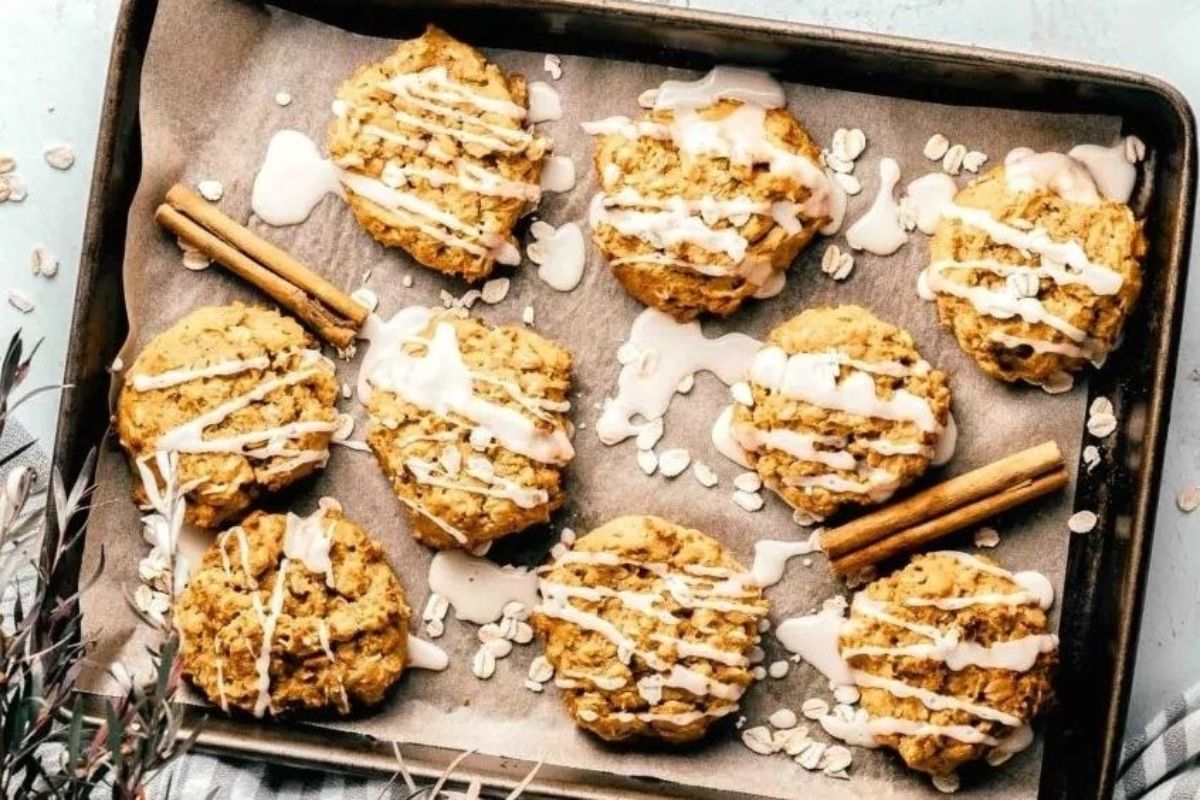 A tray of cookies with a cinnamon stick for added flavor.