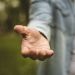 man reaching hand out with palm up, how to write a self-help book