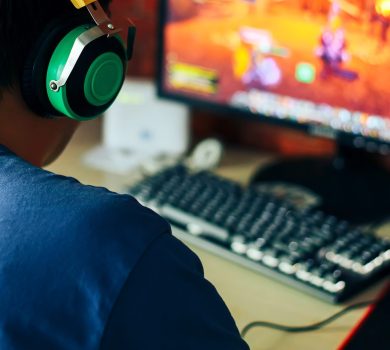 young man playing game on computer, banner