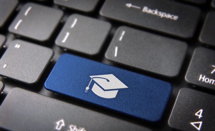 Education key with graduation hat icon on laptop keyboard.