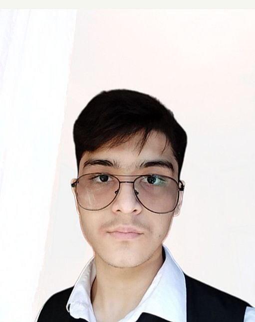 A boy with glasses looking at the camera. 