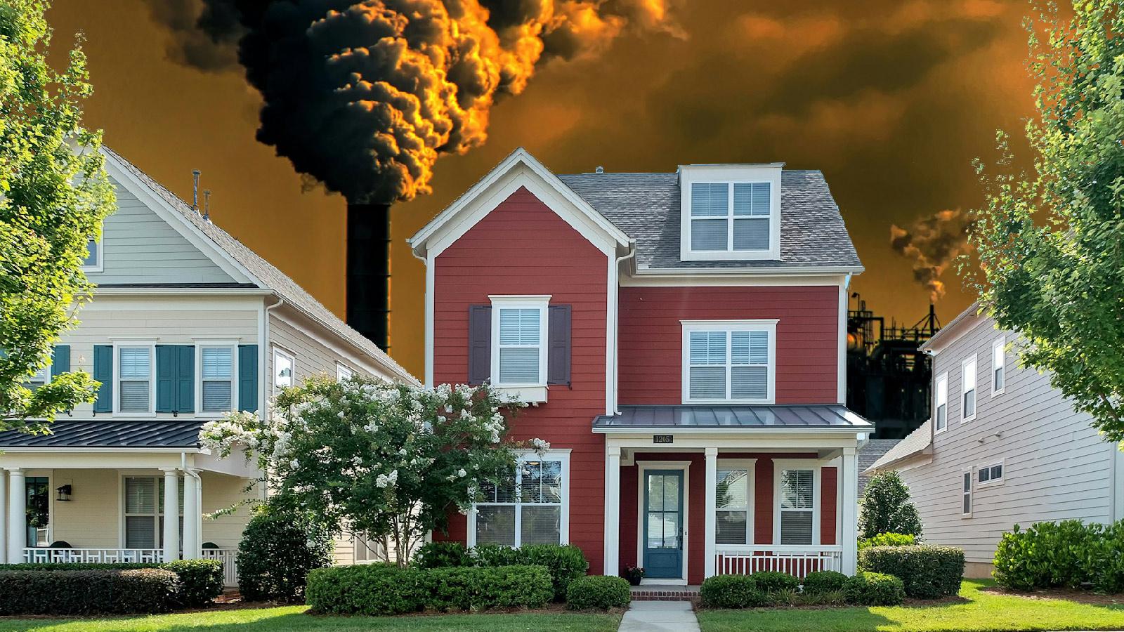 A photo illustration shows an ominous smokestack behind a suburban home