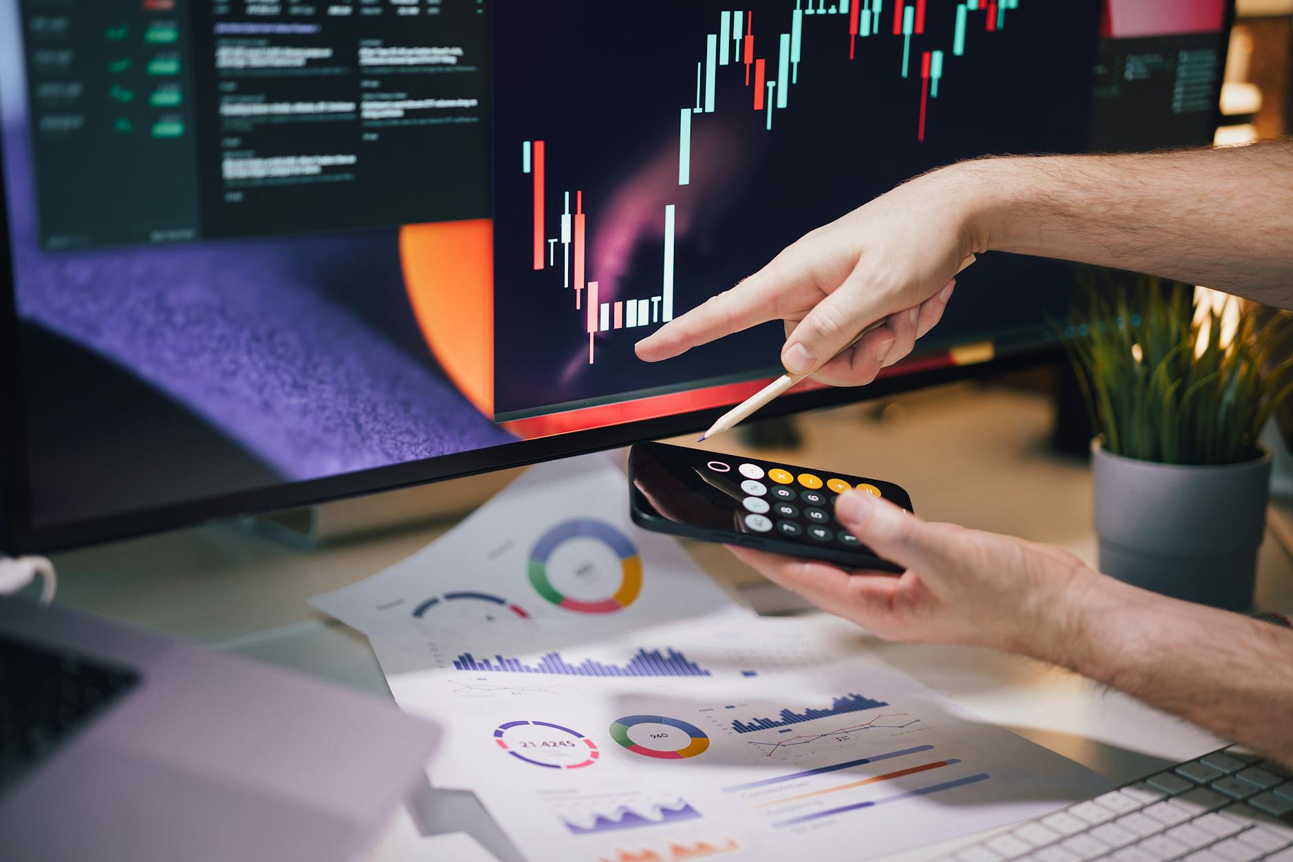 falls and rises on the stock exchange hand pointing at the chart