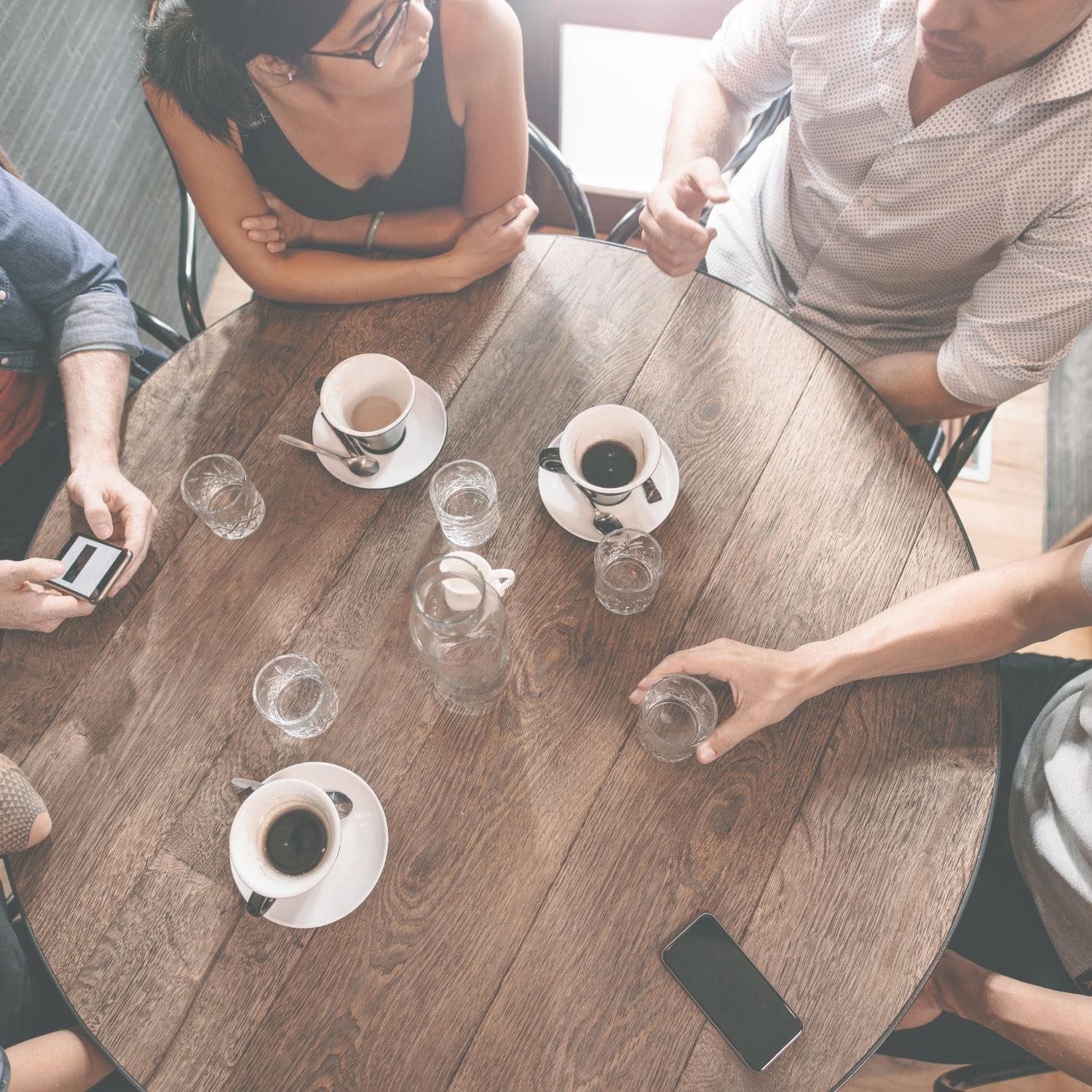 Friends around a coffee table talking about interest rates