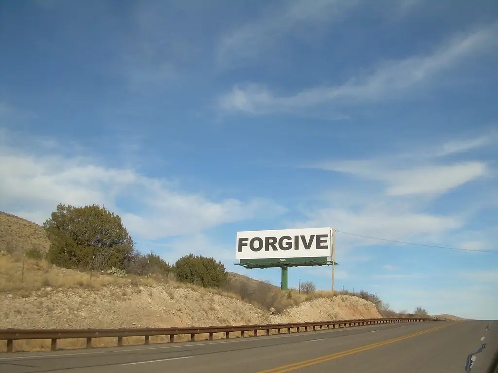 Forgive sign on a highway