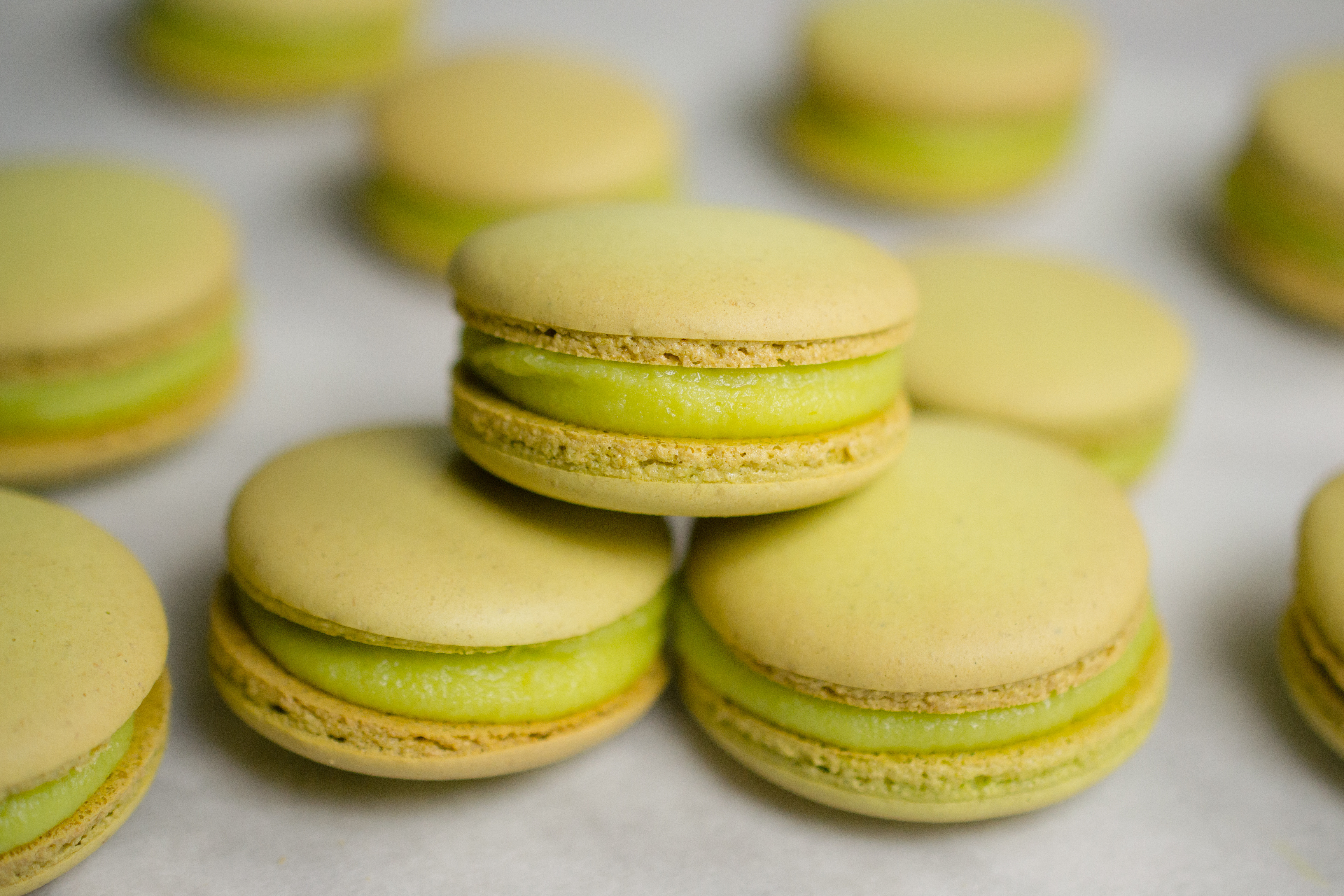 three apple macarons stacked in a triangle