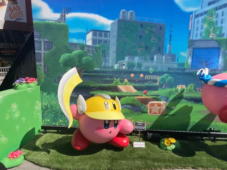 A Kirby statue wearing a construction hat while at an event. The Kirby 30th anniversary was celebrated in 2022.