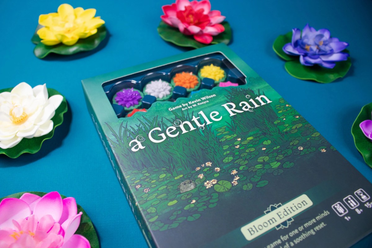 a gentle rain game box with lily flower props