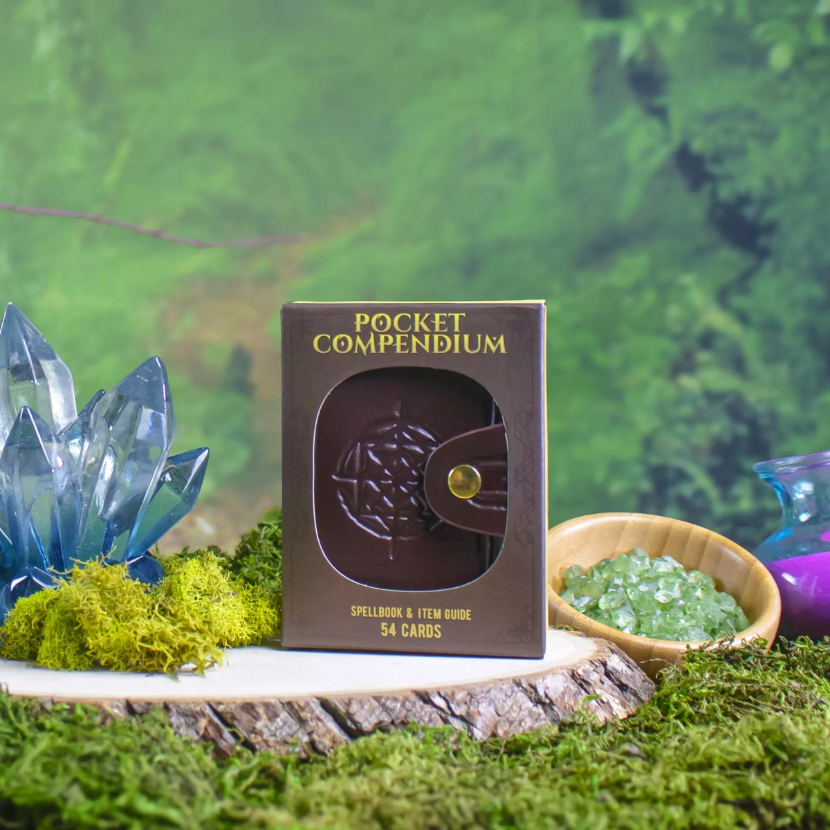 Zack Marsh Design, pocket compendium product photography of product packaging on a wood round with fantasy props around it