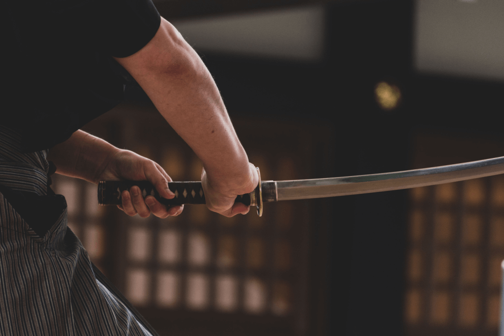 Someone holding a Japanese sword.