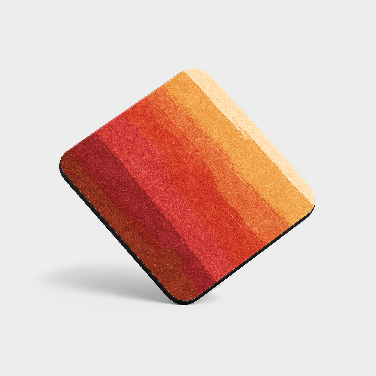 Ember Gradient Cork-Back Coaster with broad uneven bands shifting from cream and gold to red and burgundy on a light gray background.