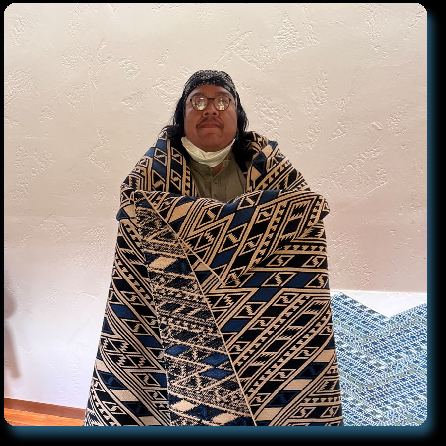 Zefren wearing a Diamond Twill Tapestry woven by Martha Stanley