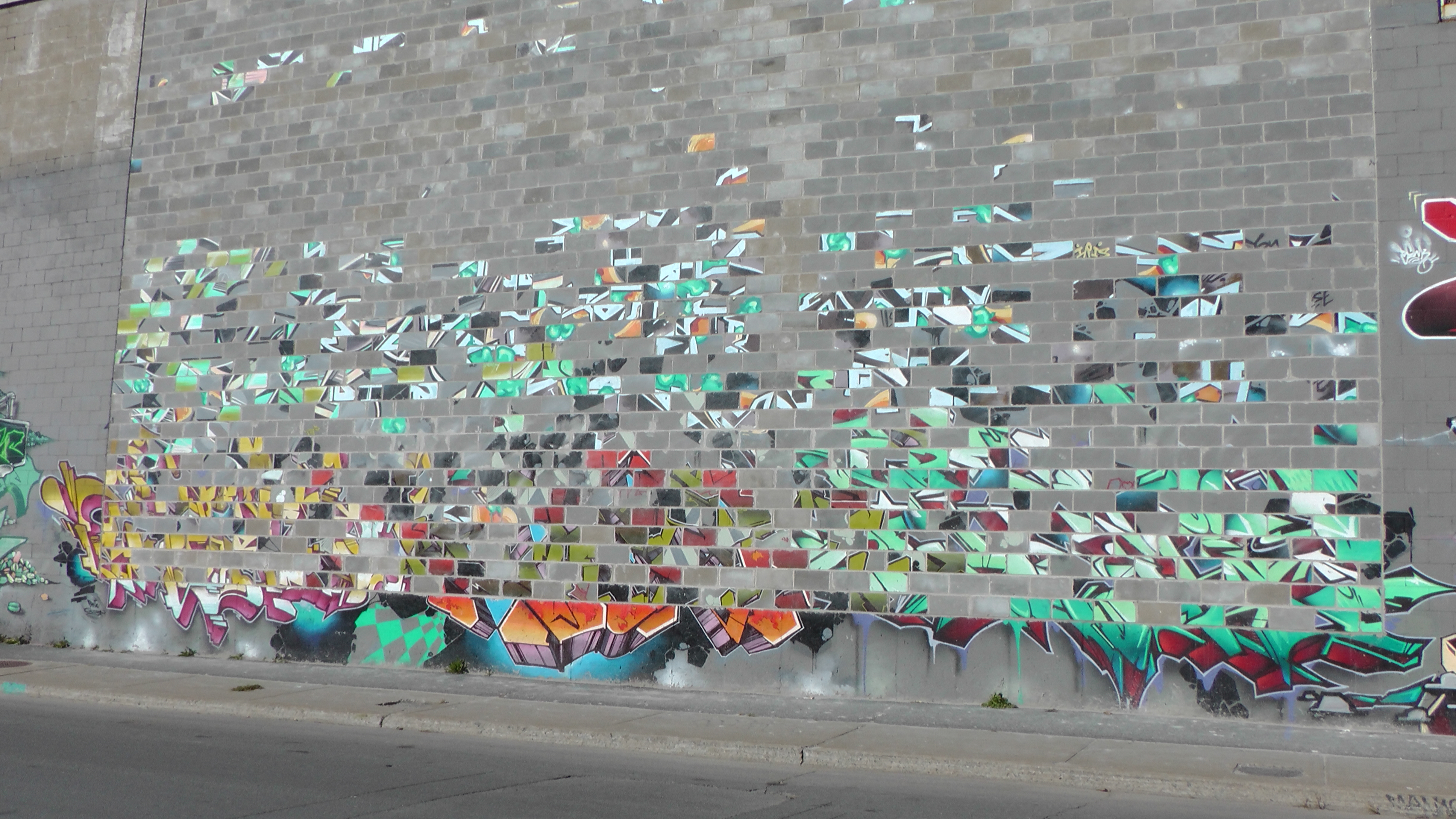 What happens when you do brick work on a wall with graffiti.