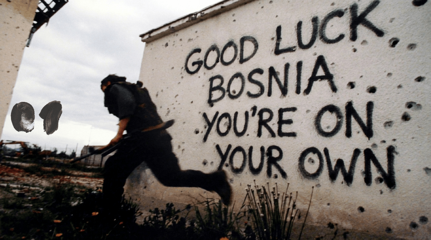 A war-damaged wall with graffiti reading “Good luck Bosnia, you’re on your own,” with a person running past in a conflict zone